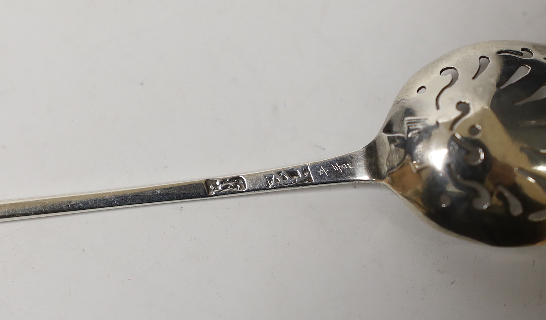 An 18th century silver mote spoon, maker, TW, 12.4cm.
